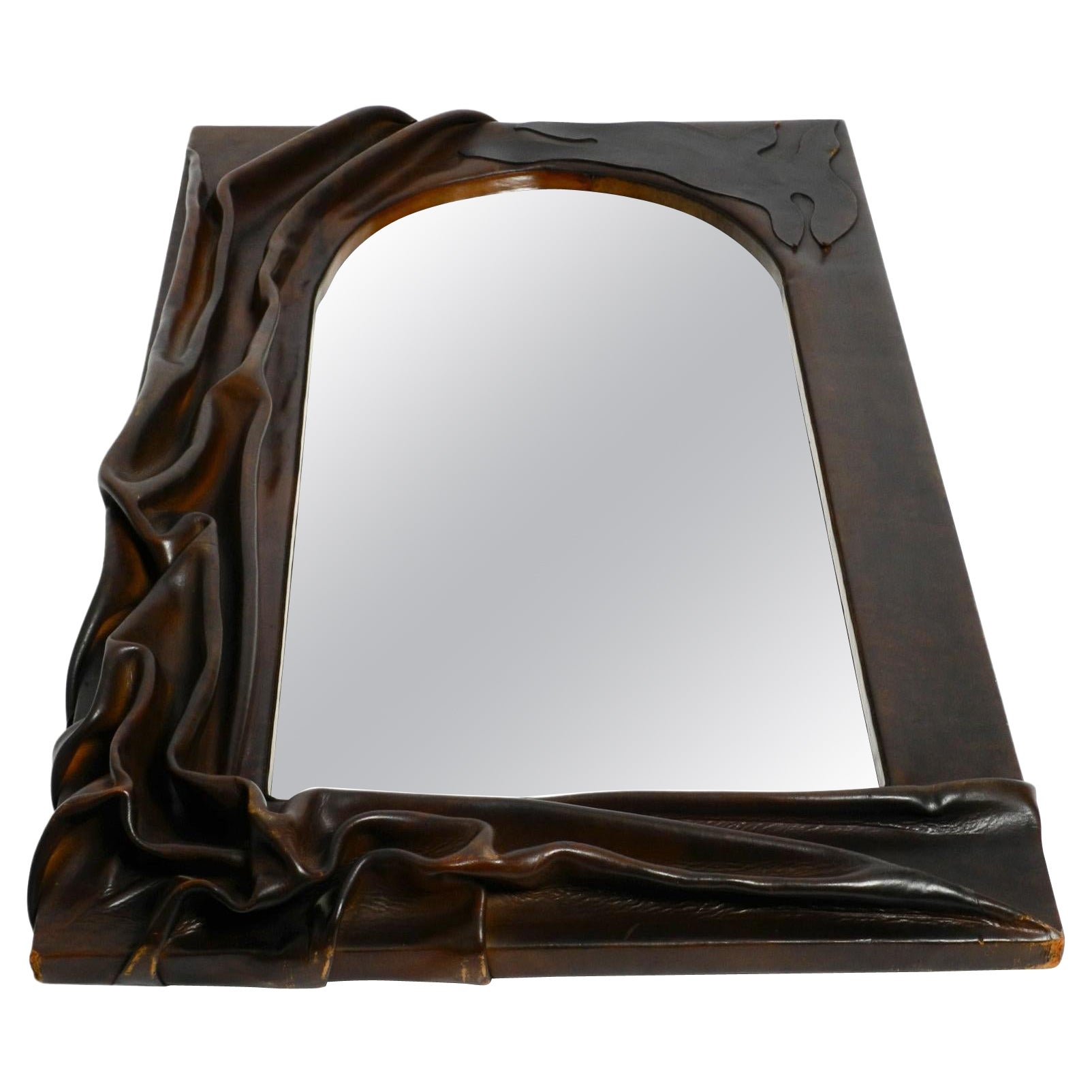 70s large wooden wall mirror with an elaborate and thick flowing leather cover 