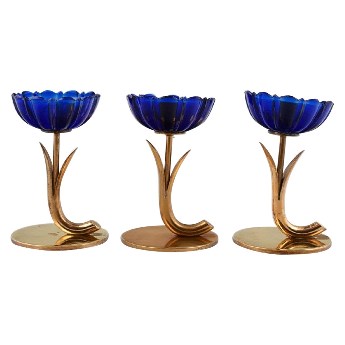 Gunnar Ander for Ystad Metall, Three Candlesticks in Brass and Blue Art Glass