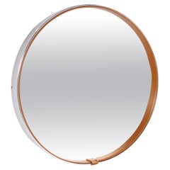 Round mirror covered with leather and chrome, made in France in the 1970s.