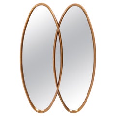 Miroir sculptural double ovale doré 