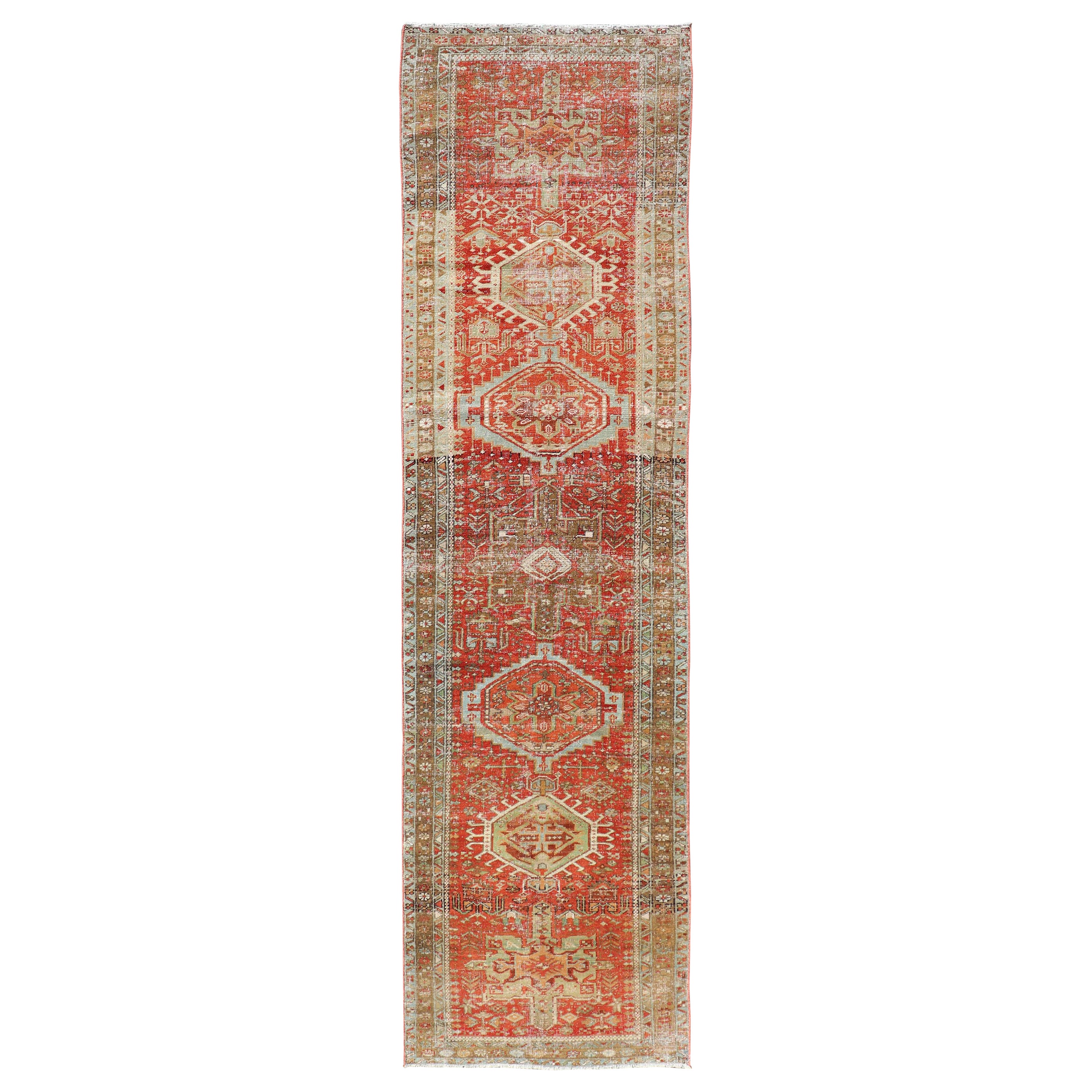 Antique Persian Heriz Distressed Runner with Geometric Medallions in Soft Colors For Sale