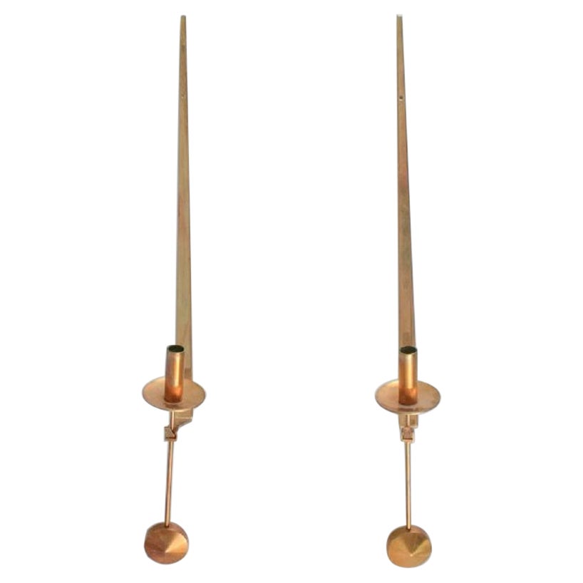 Skultuna, Sweden. A pair of brass candlesticks for wall hanging. 