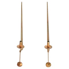 Skultuna, Sweden. A pair of brass candlesticks for wall hanging.