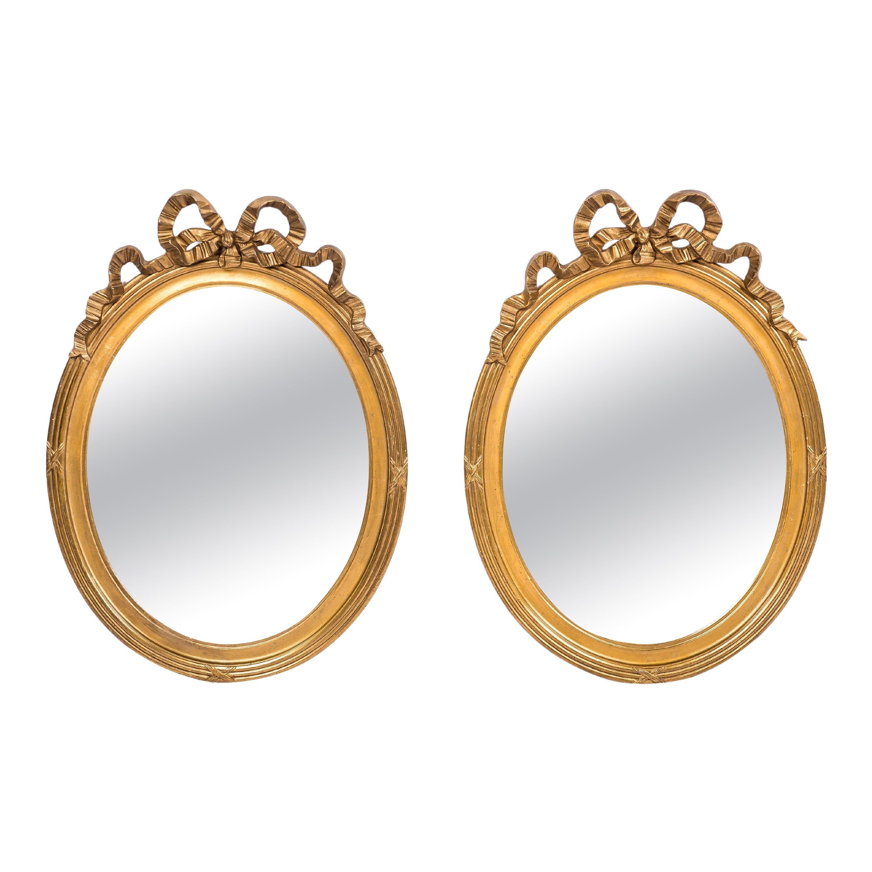 Paire de miroirs ovales français anciens du 19ème siècle en or doré avec ruban en forme de nœud papillon