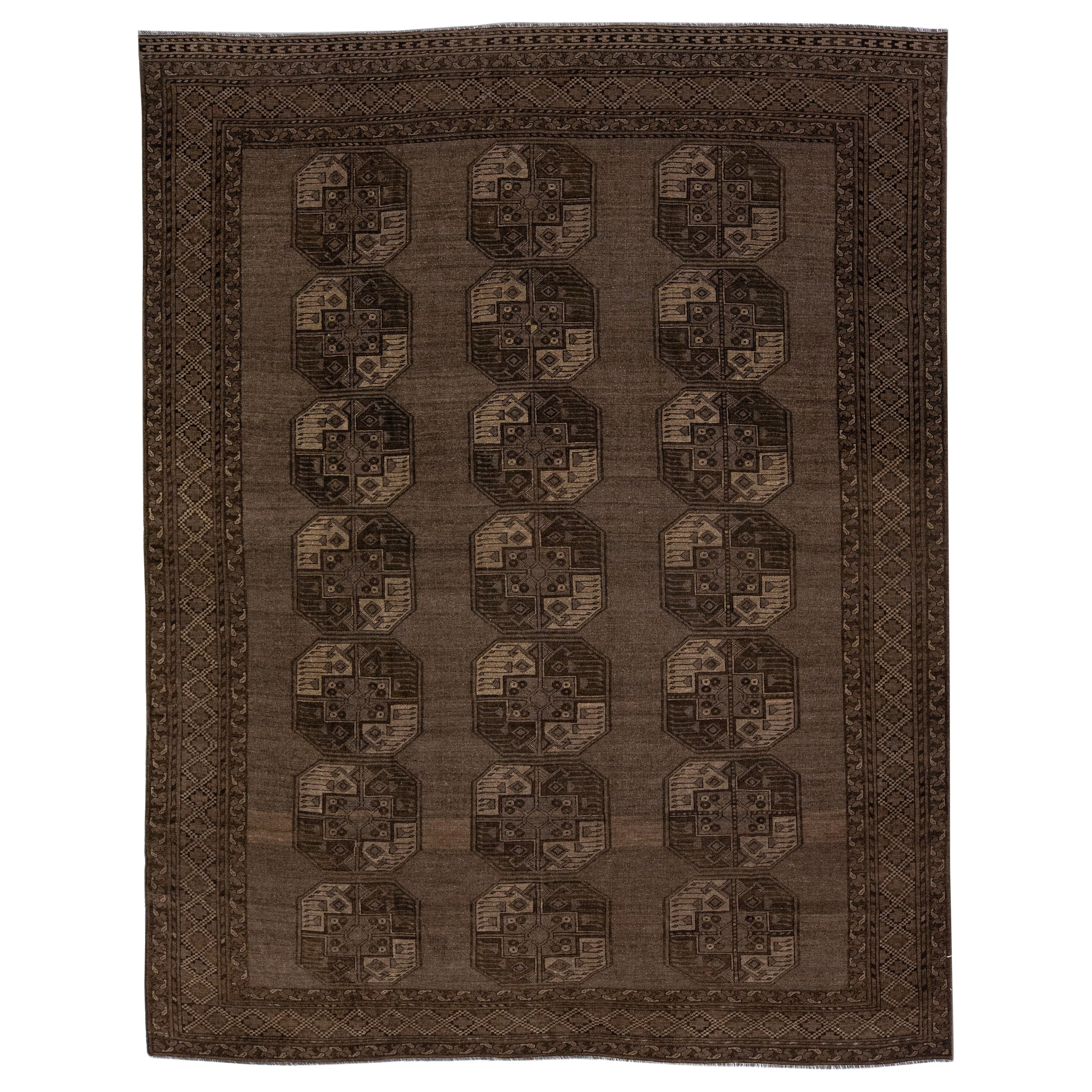 1930s Antique Turkmen Handmade Persian Wool Rug with Geometric Pattern in Brown For Sale