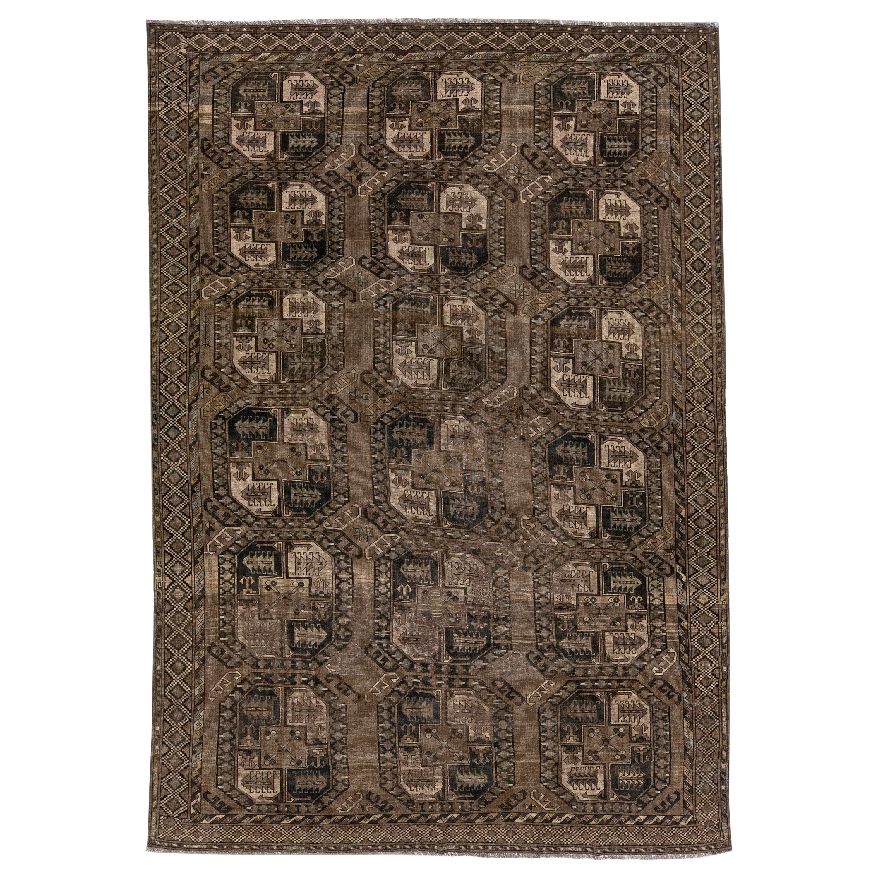 Geometric Handmade Antique Turkmen Persian Wool Rug with Brown Field For Sale