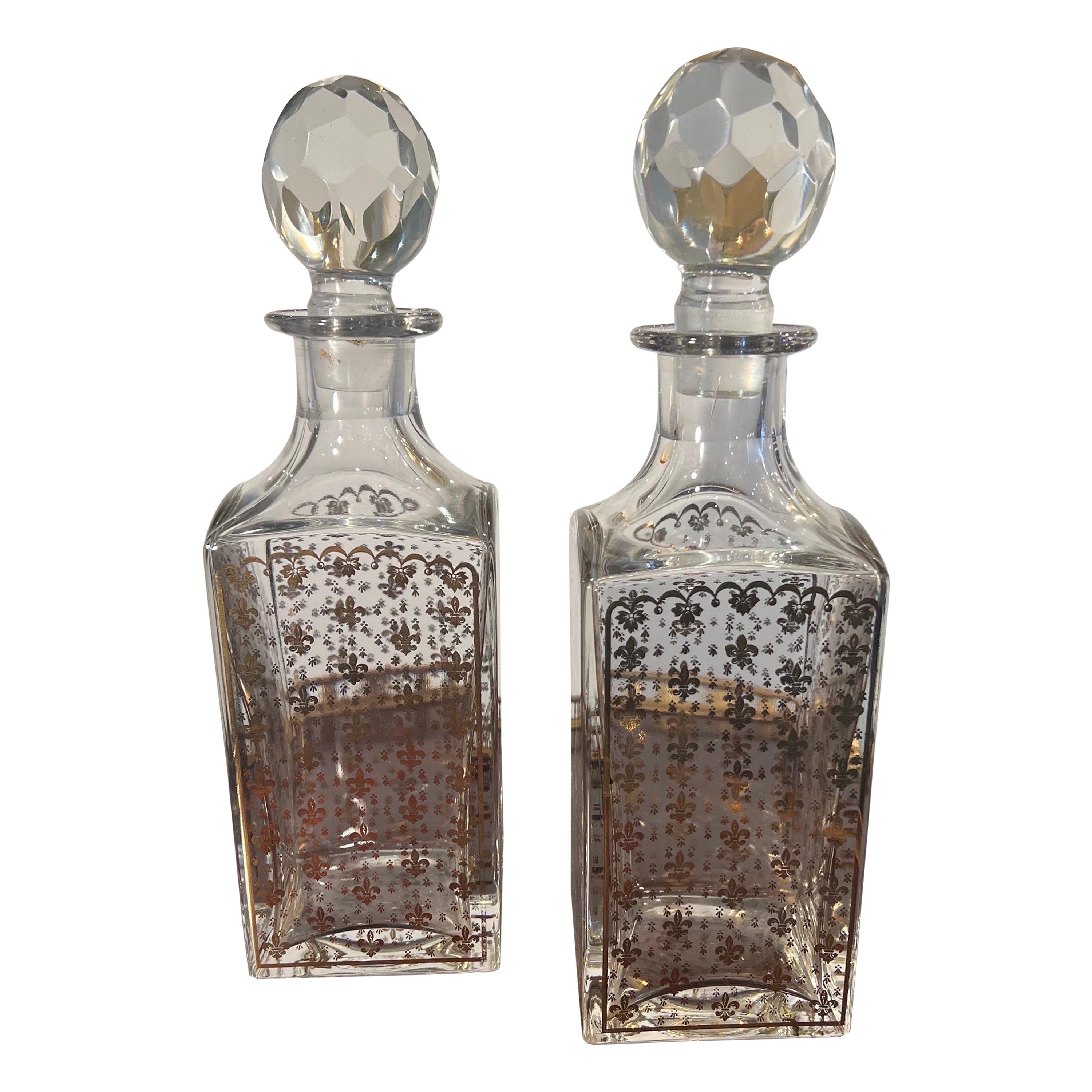 Pair of  crystal whiskey decanters with fleur de lis motifs  For Sale