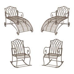 SUITE OF TWO IRON GARDEN CHAISE LOUNGES AND A PAiR OF ROCKING ARMCHAIRS