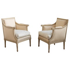 Pair Of French 19th Century Hand Painted Bergere Chairs In Antique White Patina