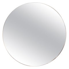A contemporary Italian large round brass mirror, 21st Century.