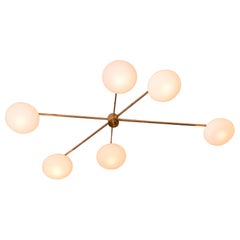 Asymetrical brass and opaline shade flush mount