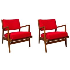 Pair of Jens Risom solid walnut lounge chairs with ottoman