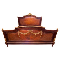 A fine 19th c French Louis XVI kingwood and rosewood parcel gilt carved King bed