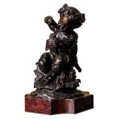 Bronze - Patine marron  Un faune avec des hiboux au-dessus d'une base en marbre rouge - 19ème siècle