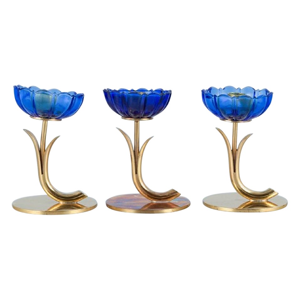 Gunnar Ander for Ystad Metall, Three Candlesticks in Brass and Blue Art Glass For Sale