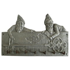 Used Jolly Aluminum and Iron Keyboard/Coat Rack with Two Dwarves