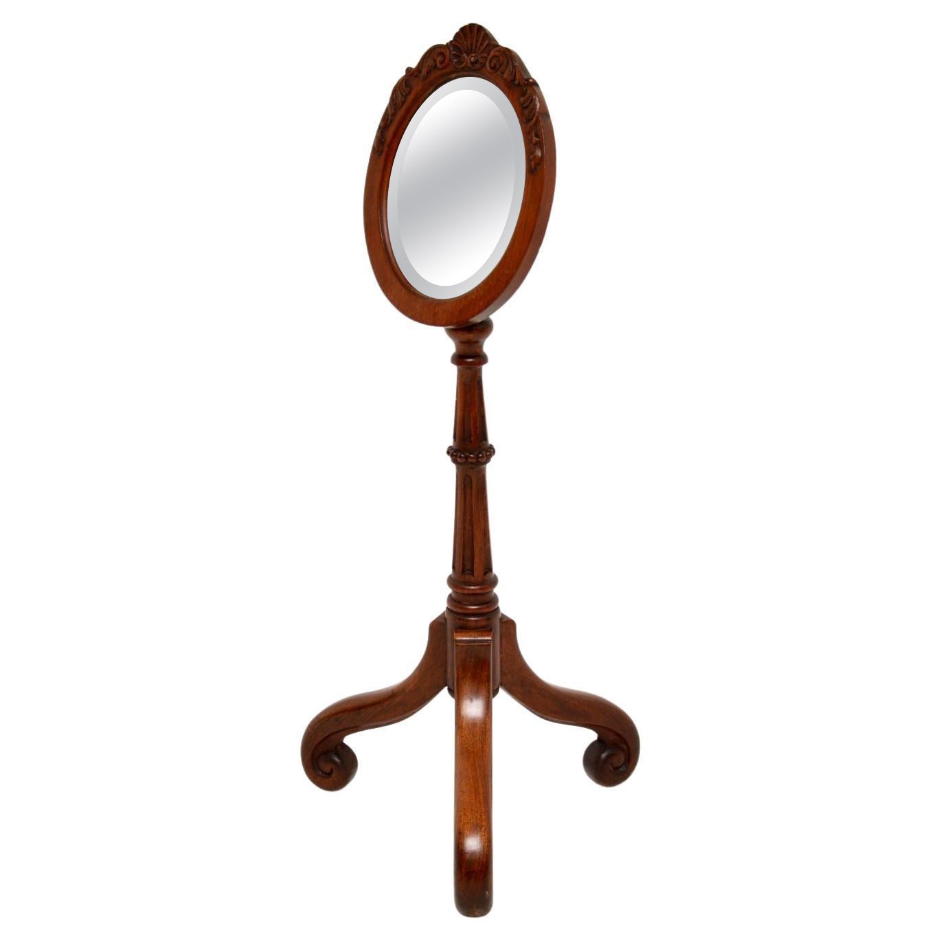 A beautiful and quite charming antique Victorian shaving mirror. This was made in England, it dates from around the 1860-1880 period.

This is of superb quality, and is beautifully carved. The oval mirror sits on a tripod base, the mirror can be
