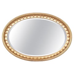 Miroir ovale biseauté et doré du XIXe siècle