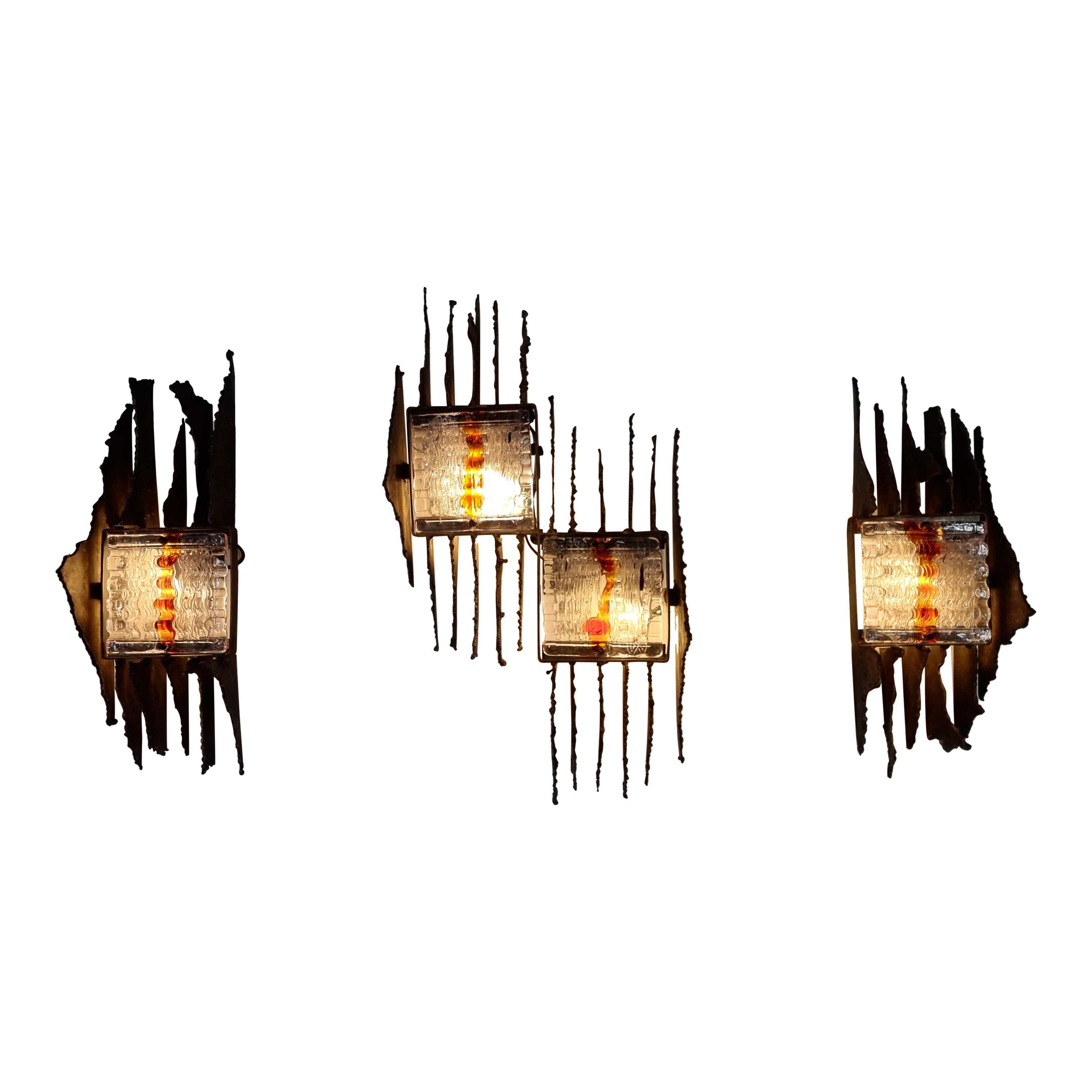 Brutalist Mid-Century Modern vintage appliques by Tom Ahlström and Hans Ehrlich manufactured by A & E Lights Sweden in the 1970s.

The lamps have a heavy dark iron structure and a two-tone (transparent and amber) texture in their unique