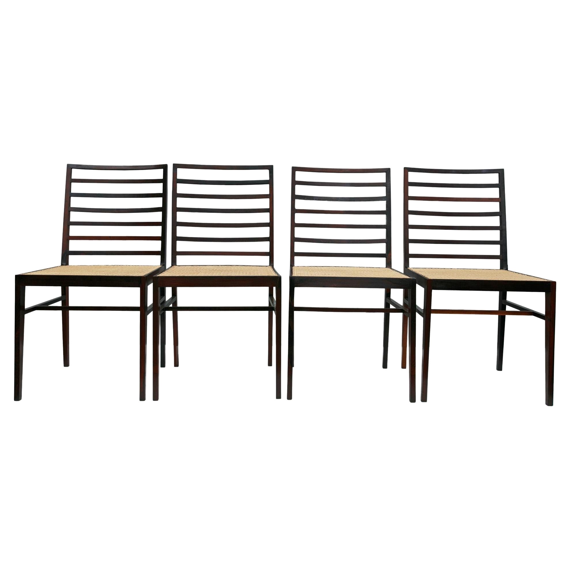 Available today, this Mid-Century Modern chair set made in Brazilian rosewood and caning designed by Joaquim Tenreiro in Brazil during the fifties is absolutely magnificent!

Each chair features four delicate legs, a seat in cane and a backrest