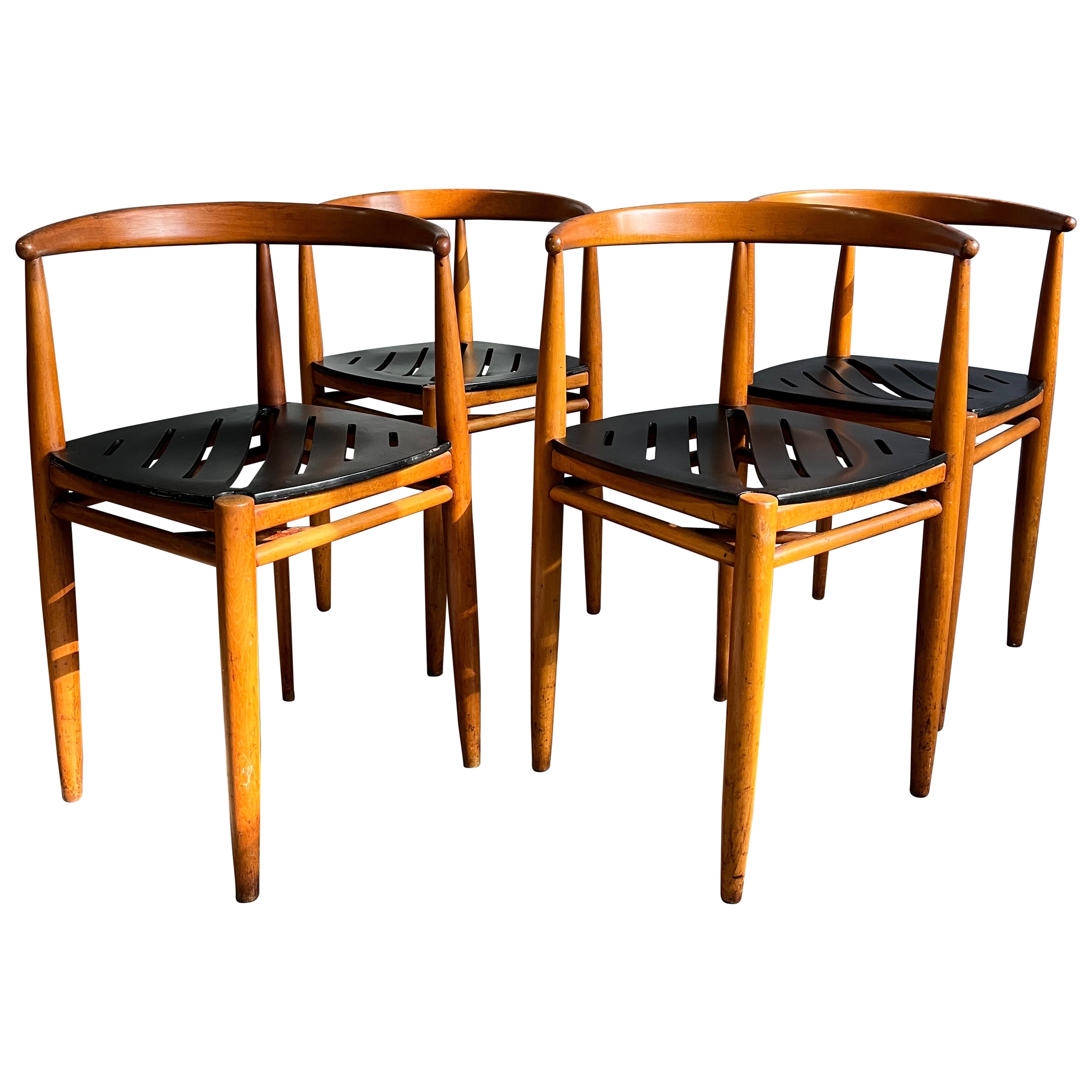Beautiful sexy of 4 chairs boy Gemla Sweden. Warm patina throughout. They sit wonderfully stacked as a space saving feature. Sculpted black lacquered seats are as comfortable as they are beautiful to look at. Sold as a set of four.

Local pickup