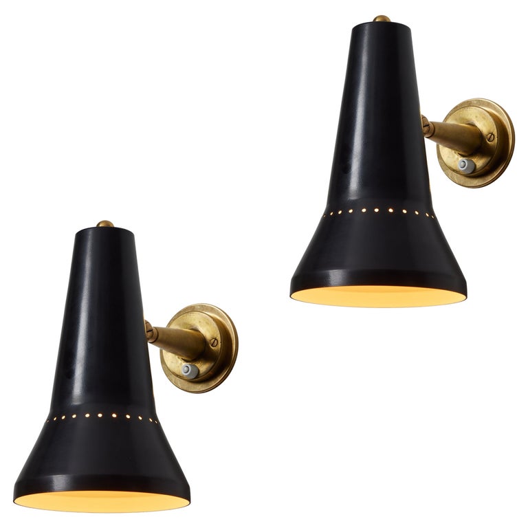 Pair of Large 1950s Stilnovo Perforated Black Metal and Brass Articulating Sconces For Sale at