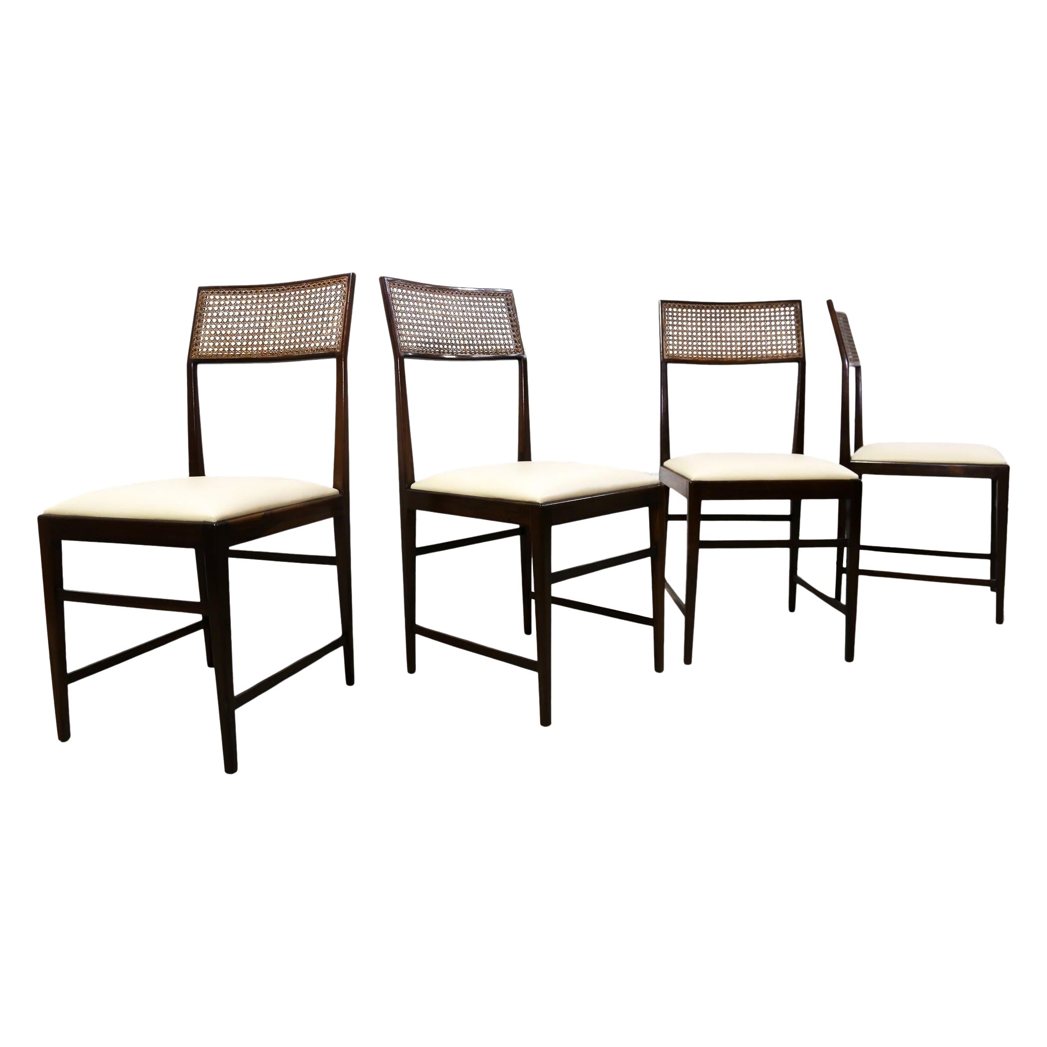 Available today, this Mid-Century Modern four chair set made in Brazilian Rosewood, Leather and Caning designed by Joaquim Tenreiro in Brazil during the fifties is absolutely magnificent!

Each chair features four delicate legs, a slim seat in off