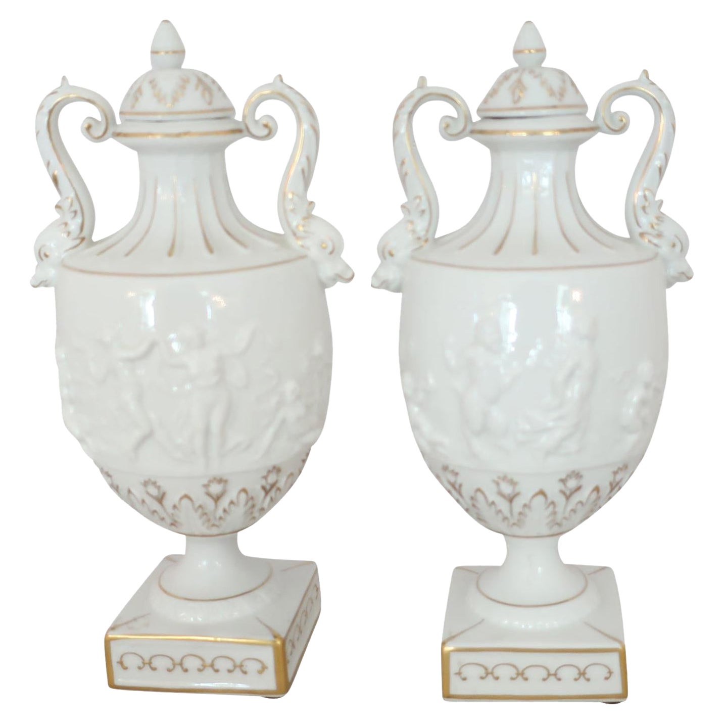 White and Gilt Capodimonte Porcelain Urns with Lids and Putti Decoration