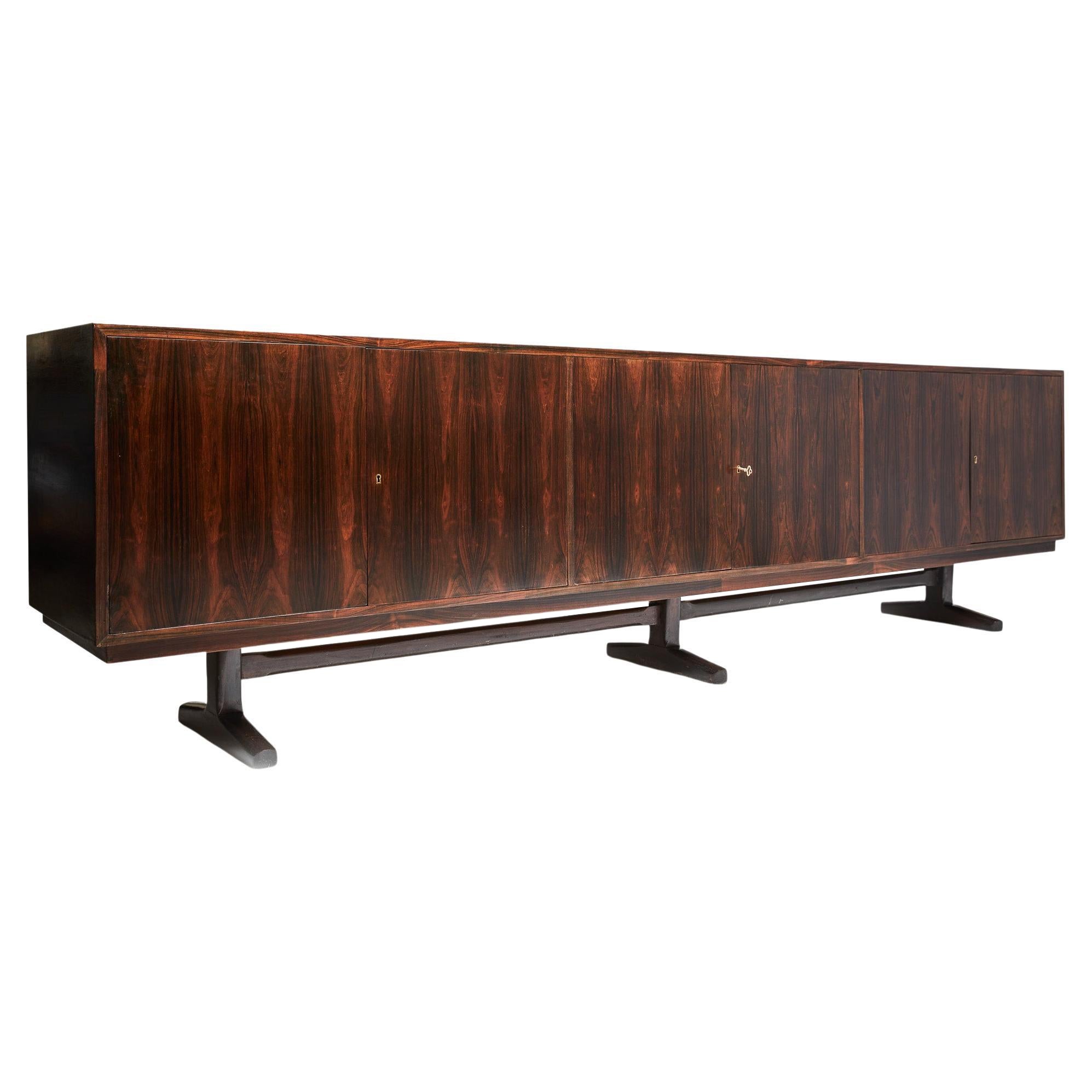 Available today, this magnificent Brazilian Modern Credenza from Novo Rumo is stately and stunning!

The Credenza is executed in Brazilian Rosewood leaf, as known as Jacaranda, and solid Jacaranda structure. The credenza is composed of three feet,