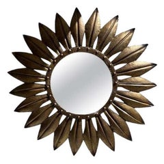 Grand miroir en fer doré à feuilles