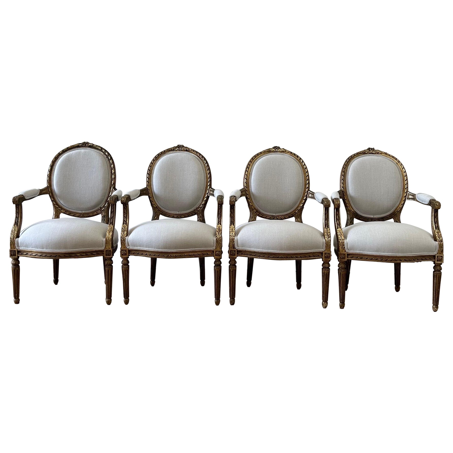 Antique French Louis XVI Style Gilt Wood Upholstered Linen Arm Chairs For Sale