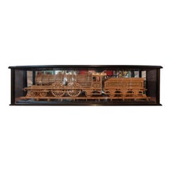 Carved Wood Model of a Locomotive in Black Lacquered and Glass Case