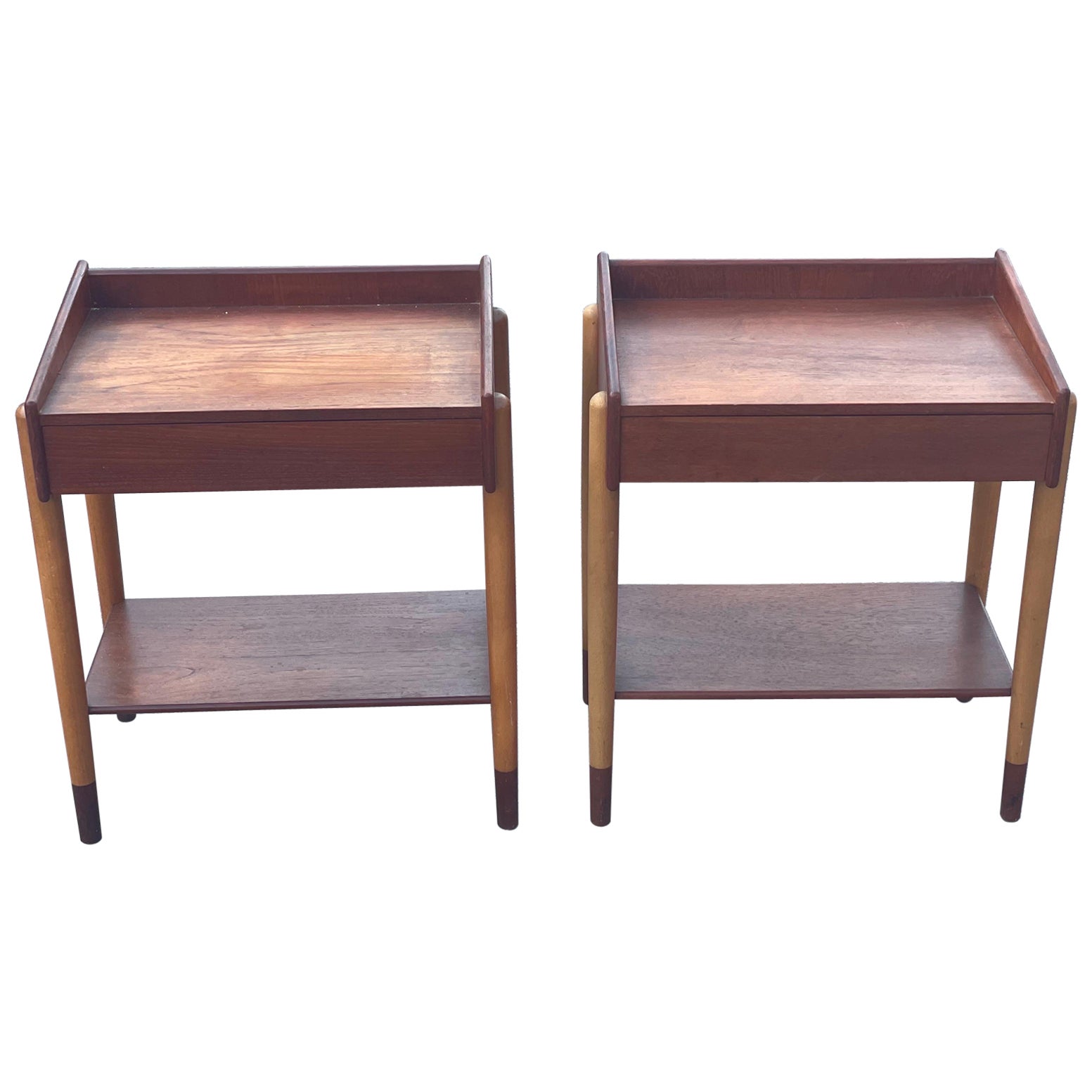 Discover the essence of Danish Mid-Century Modern design with this rare set of two bedside tables. Designed by Børge Mogensen in the 1950s, these tables showcase the beauty of teak wood and the craftsmanship of Søborg Møbler. With their Minimalist