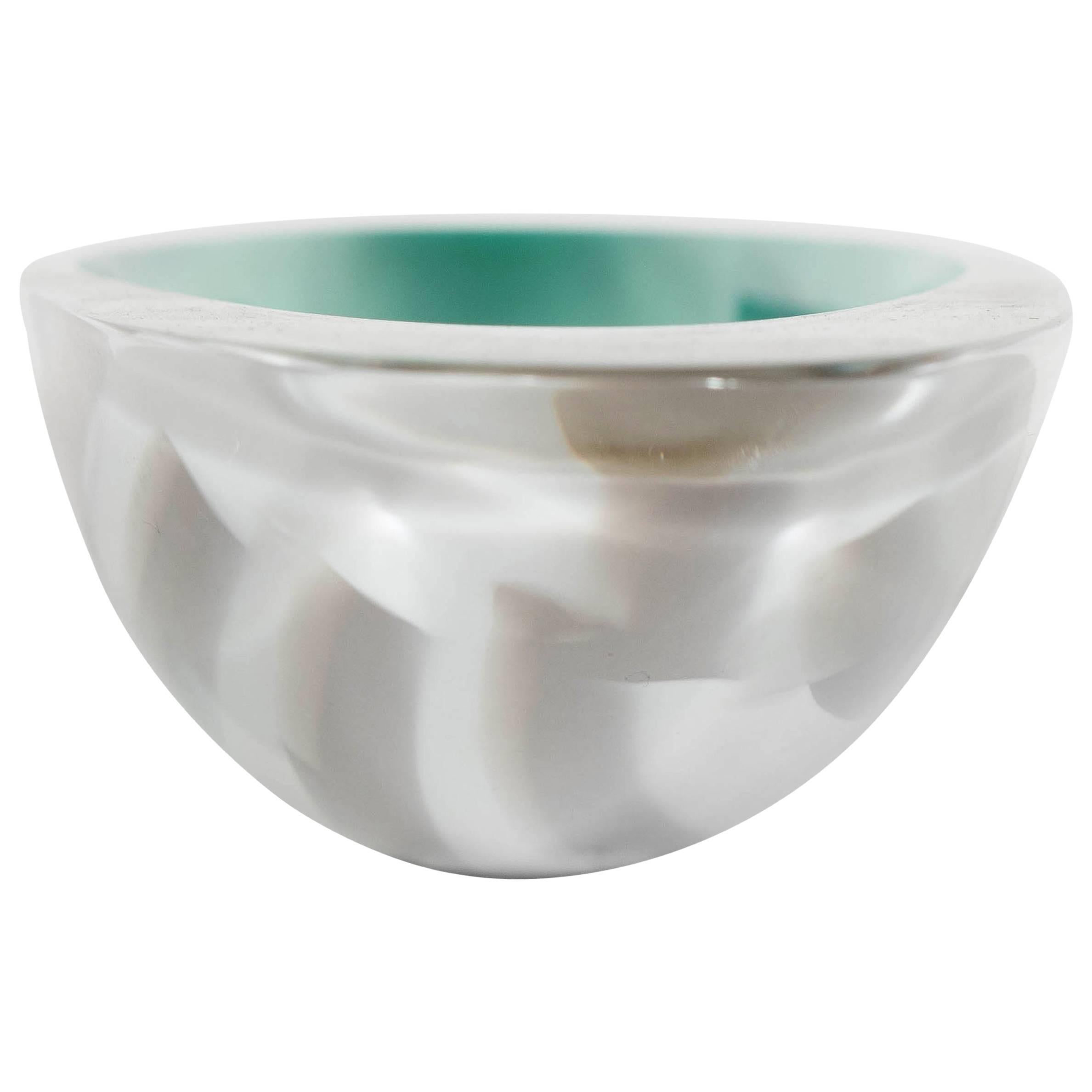 This exceptional Mid-Century Modernist Murano glass bowl features a shallow elongated ovoid shape with long bands of inter-woven colored bands in tones of jade, ivory and pewter, it is a Limited Edition (marked 18/101) and is signed Seguso and is