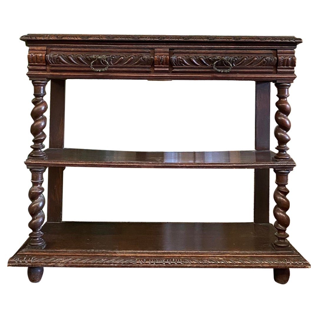 This Fabulous Antique French Serving or Console Table with Red Marble Top underneath the hatch. The style is of King Henri II and displays decorative barley twists posts. 

The French Henri II Serving Table is from Dark Oak and has two selves and