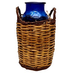 Blue Glass Bottle with Wicker Basket, circa 1930