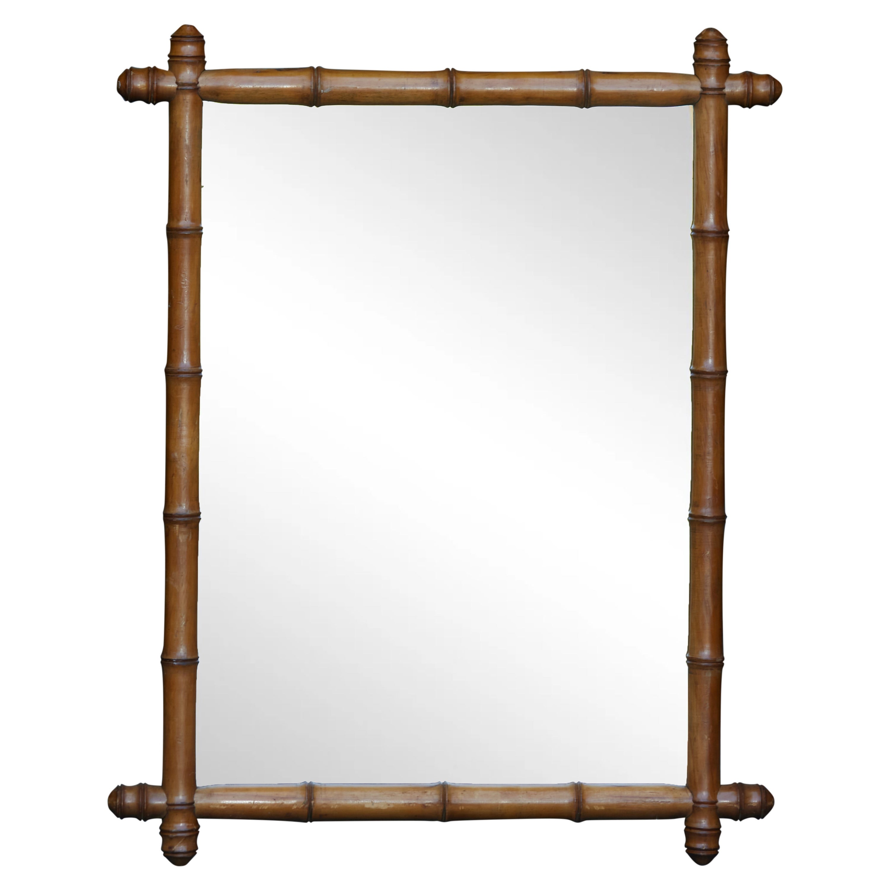 French 1920s Faux Bamboo Walnut Mirror with Protruding Corners and Brown Patina For Sale