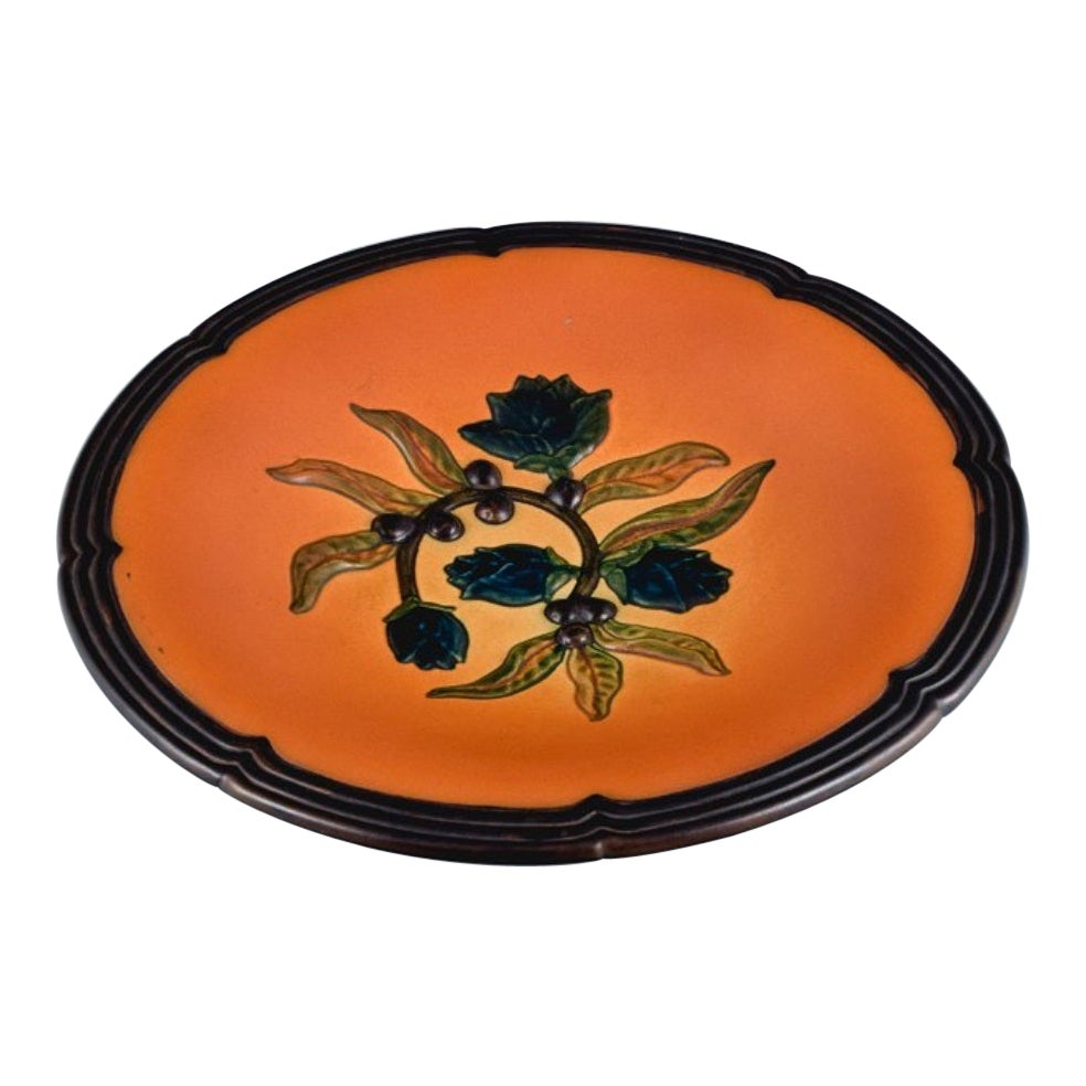 Bol en céramique à motifs floraux Ipsens, Danemark. Glaçure dans les tons orange-vert.
