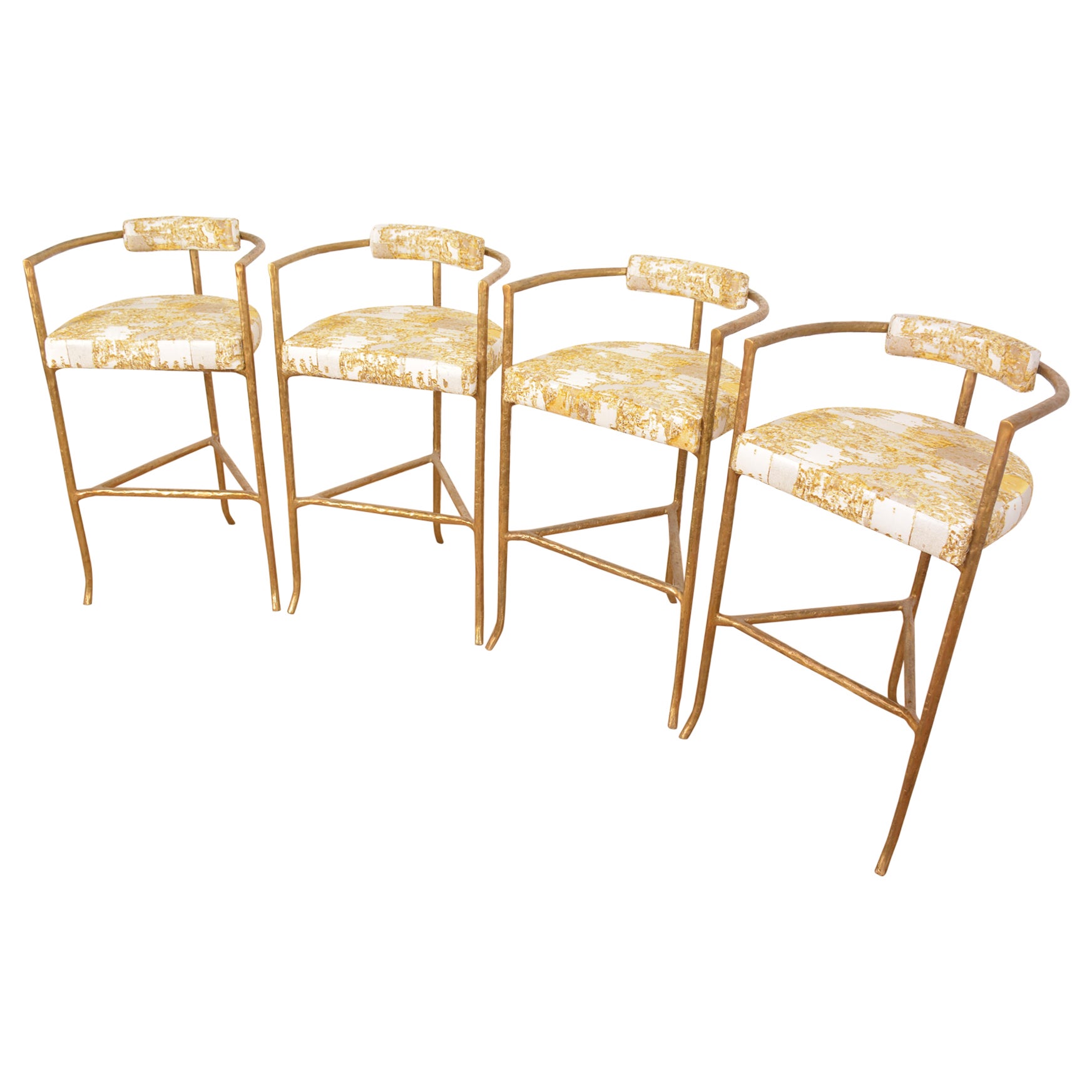 In stock and ready to ship. Two counter-stools hand made of cast bronze with matte gold finish, and a comfortable ivory boucle seat cushion and backrest.

In the style of Alberto Giacometti, the sculptural 