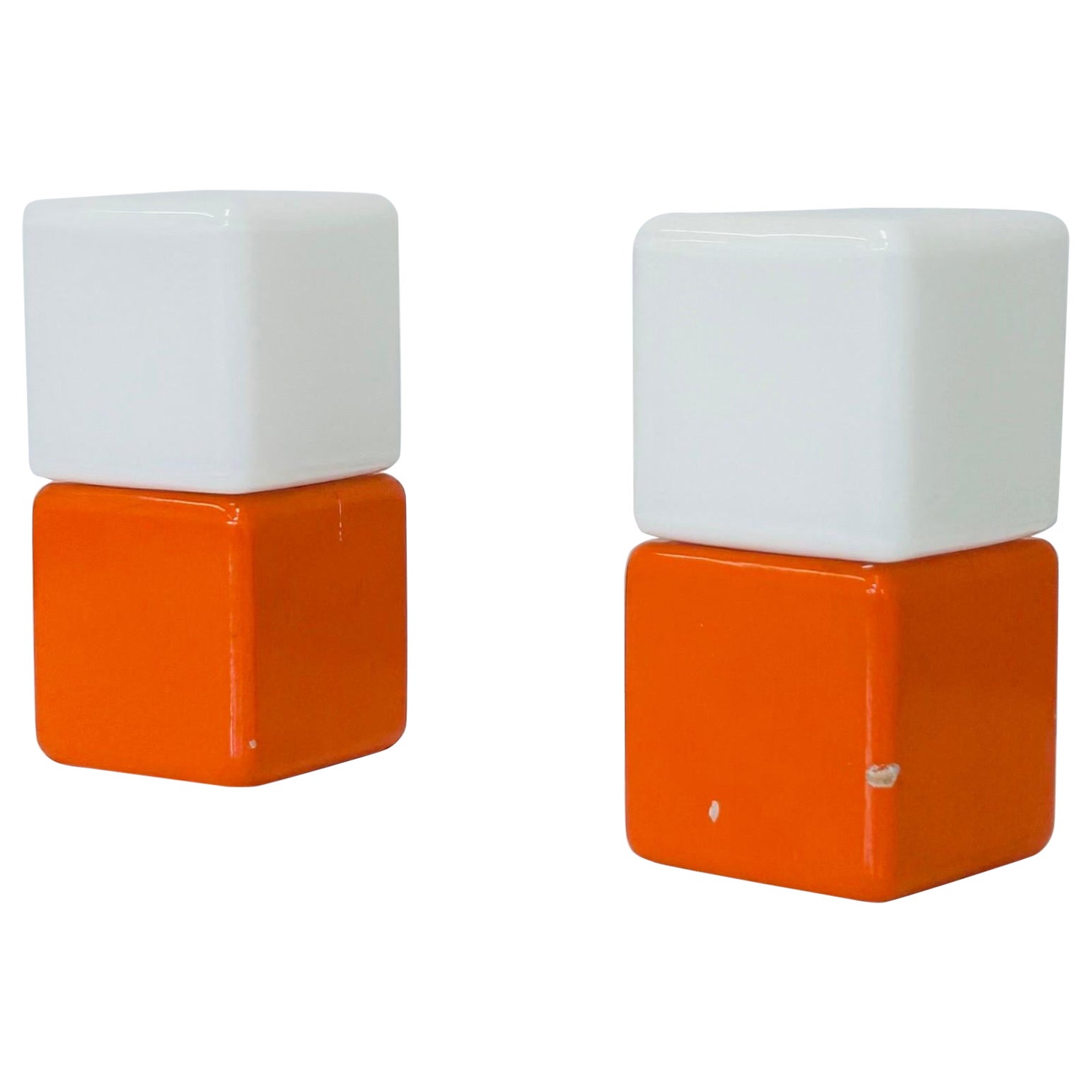 A pair of rare night lamps, designed by the renowned Danish lighting designer Svend Aage Holm Sørensen in the early 1960s. The lamps are model 4151 and were produced by Holm Sørensen & Co. They feature orange wood bases and white glass shades in a