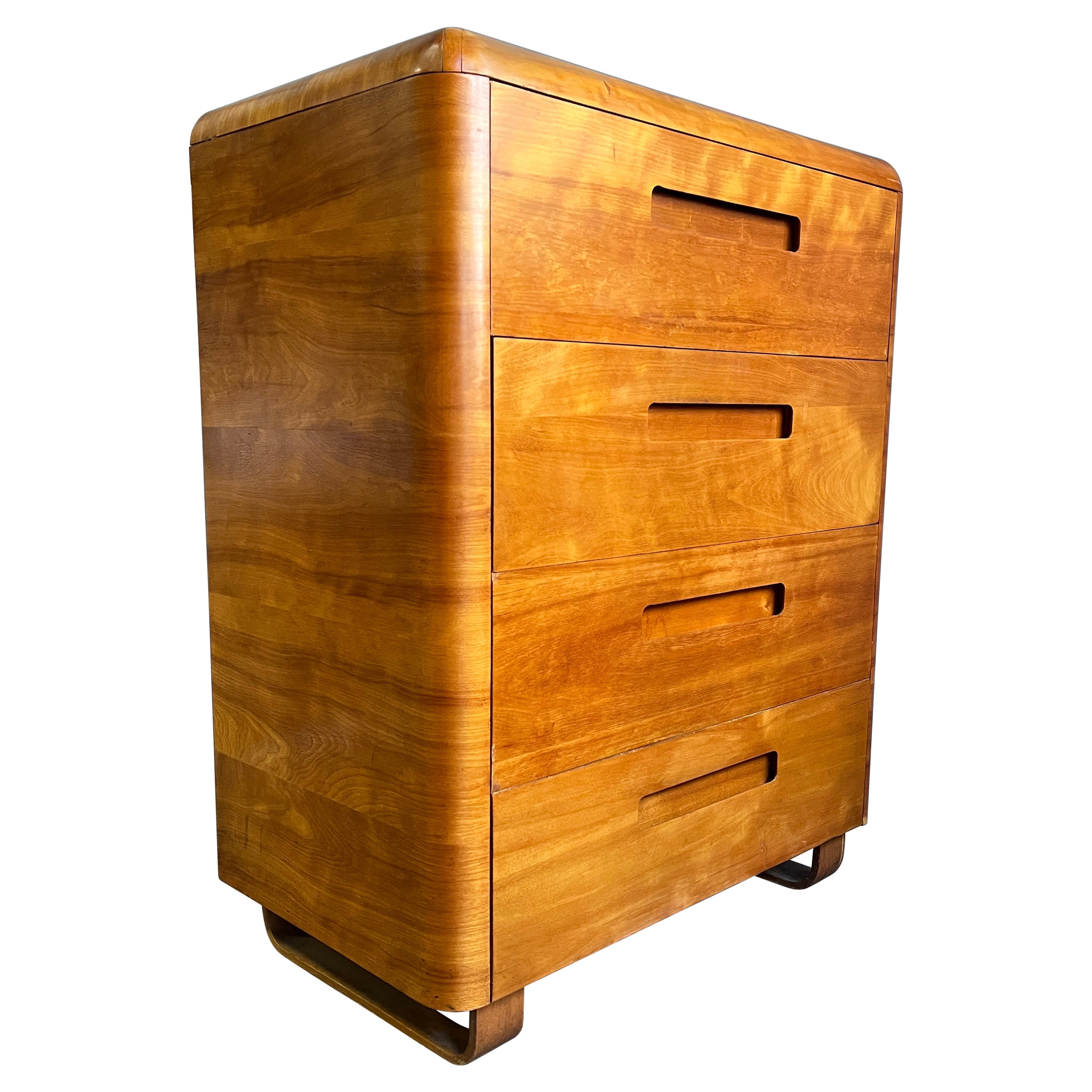 Beautiful shimmering birchwood 4 drawer dresser on sled base. Produced by Plymold for just a few years before founding Plycraft. Paul Goldman designed most of Plycraft furniture including the iconic Cherner Pretzel chair as well as designing for