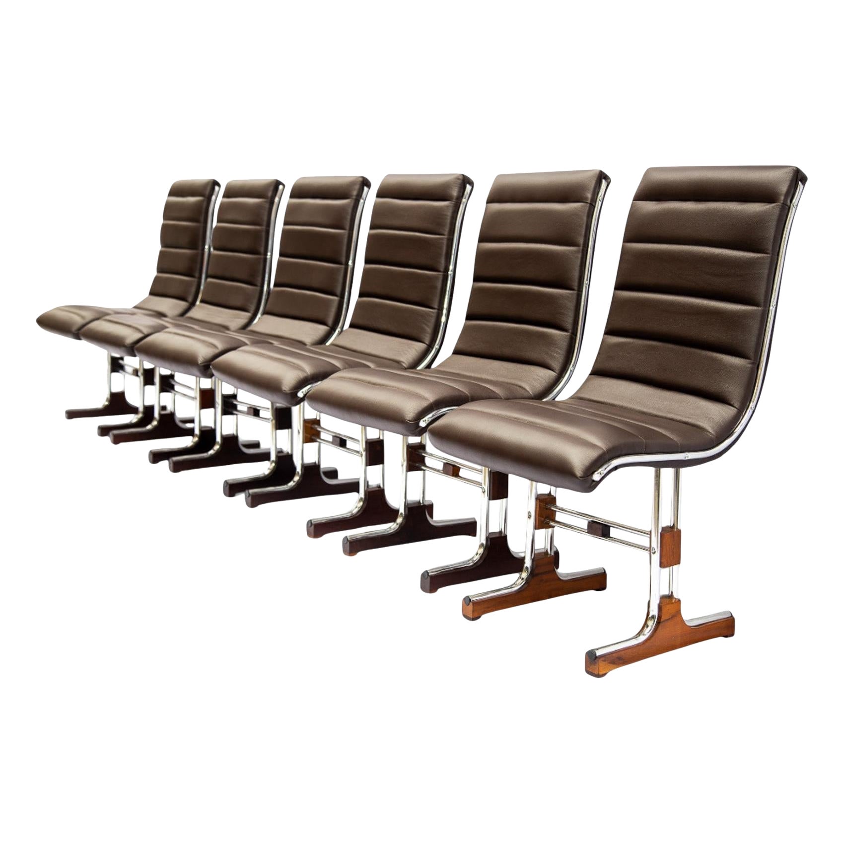 Available today, this Brazilian Modern chair set made with chromed metal, wood, and leather by Barszenski is absolutely stunning. 

The legs and base of the chair have been refurbished with chromed metal. The frame of the seat is made with