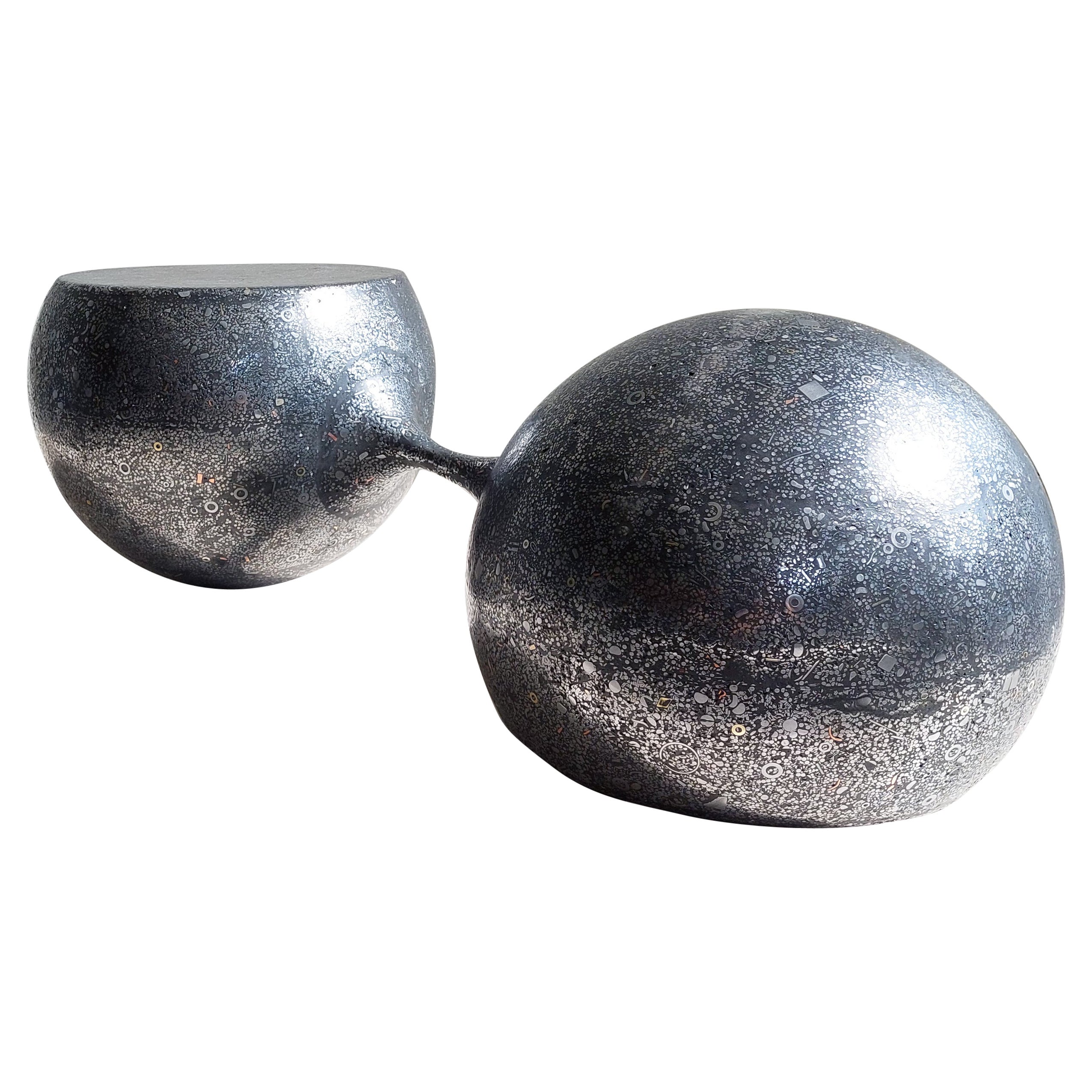 “DUMBELL” sculptural coffee table / sculpture / object /

Two metal spheres seemingly flow like mercury into each other
Molded from a self developed metal-based material: “Industrial fossil”.
Consisting mostly of metal, strengthened by a small