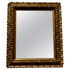 Magnifique miroir mural doré du 19ème siècle  C'est un joli miroir ancien  