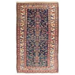 Antique Kurdish Rug With All-Over Geometric Design on a Blue Background