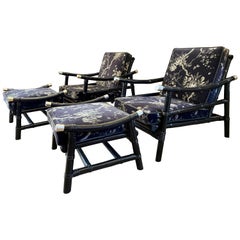 A Pair Of Ebonised Bamboo And Rattan Arm Chairs With Foot Stools By Ficks Reed 