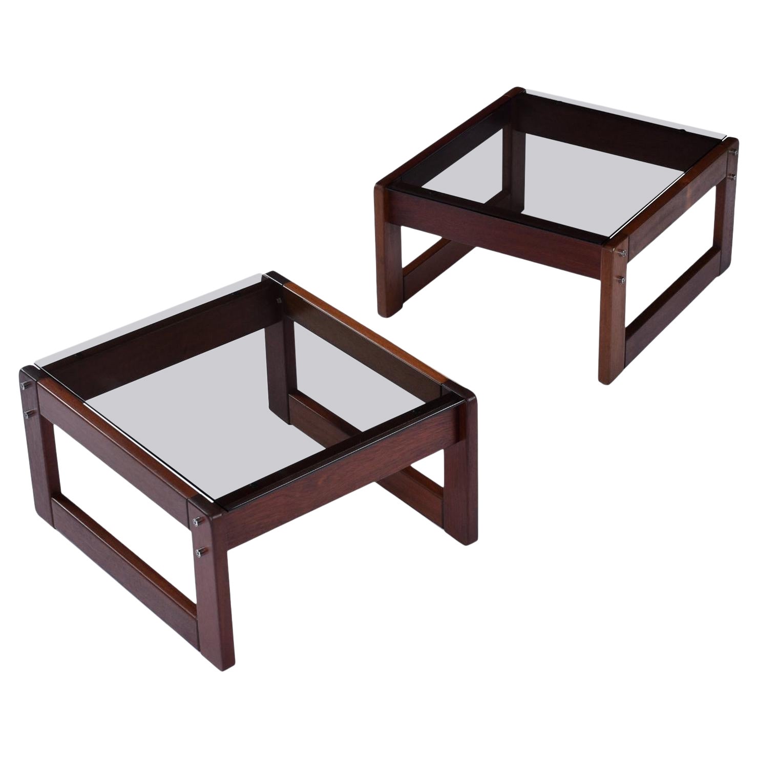 Pair of vintage 1970s Percival Lafer, Brazilian Modern side tables. The deep red hue rosewood bases support a rich smoked glass table top. Both of the tables bear the “Lafer” label. The frames are tastefully complimented by the chrome metal