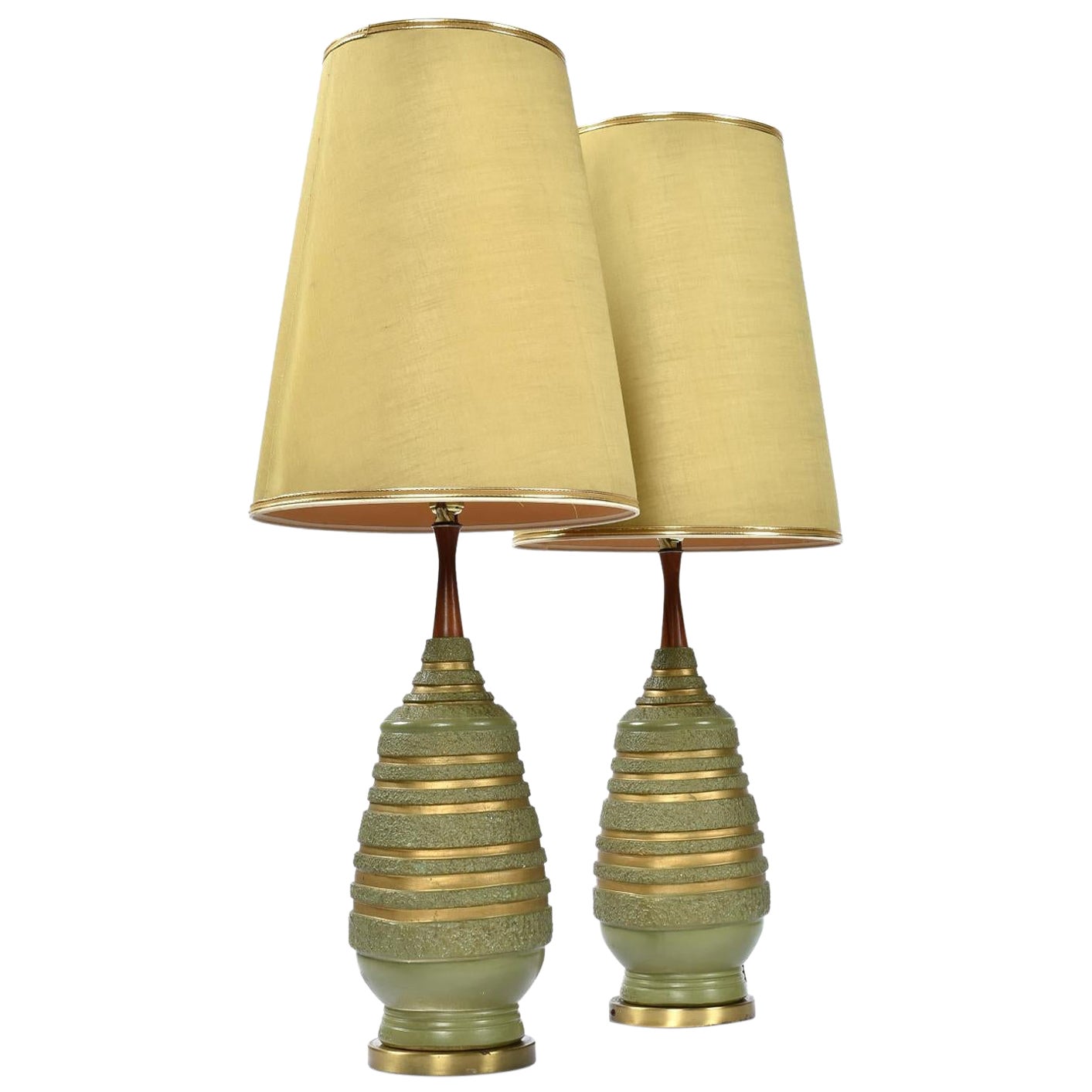 Incredible complete pair of Mid-Century Modern avacado green lamps by Plasto. These have got to be some of the most authentic Mid-Century lamps around. It is quite rare to find lamps with their original shades. These green, conical shades are