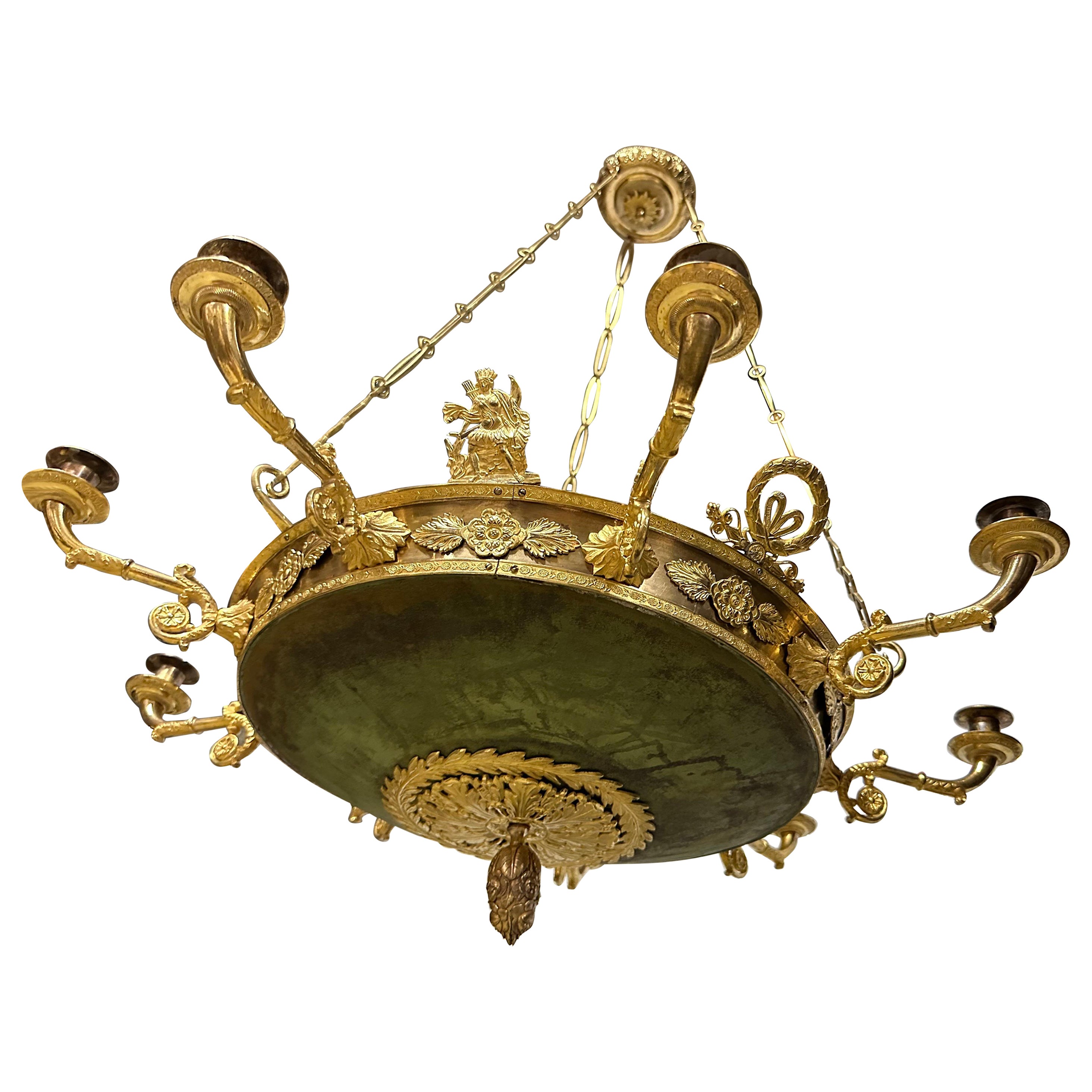 A charming Empire-lamp made around 1820. The large bowl is greenpatinated and the patina is untouched and has a very charming look with its irregularities in colour. The arms and other decorative elements are made of bronze and brass that is