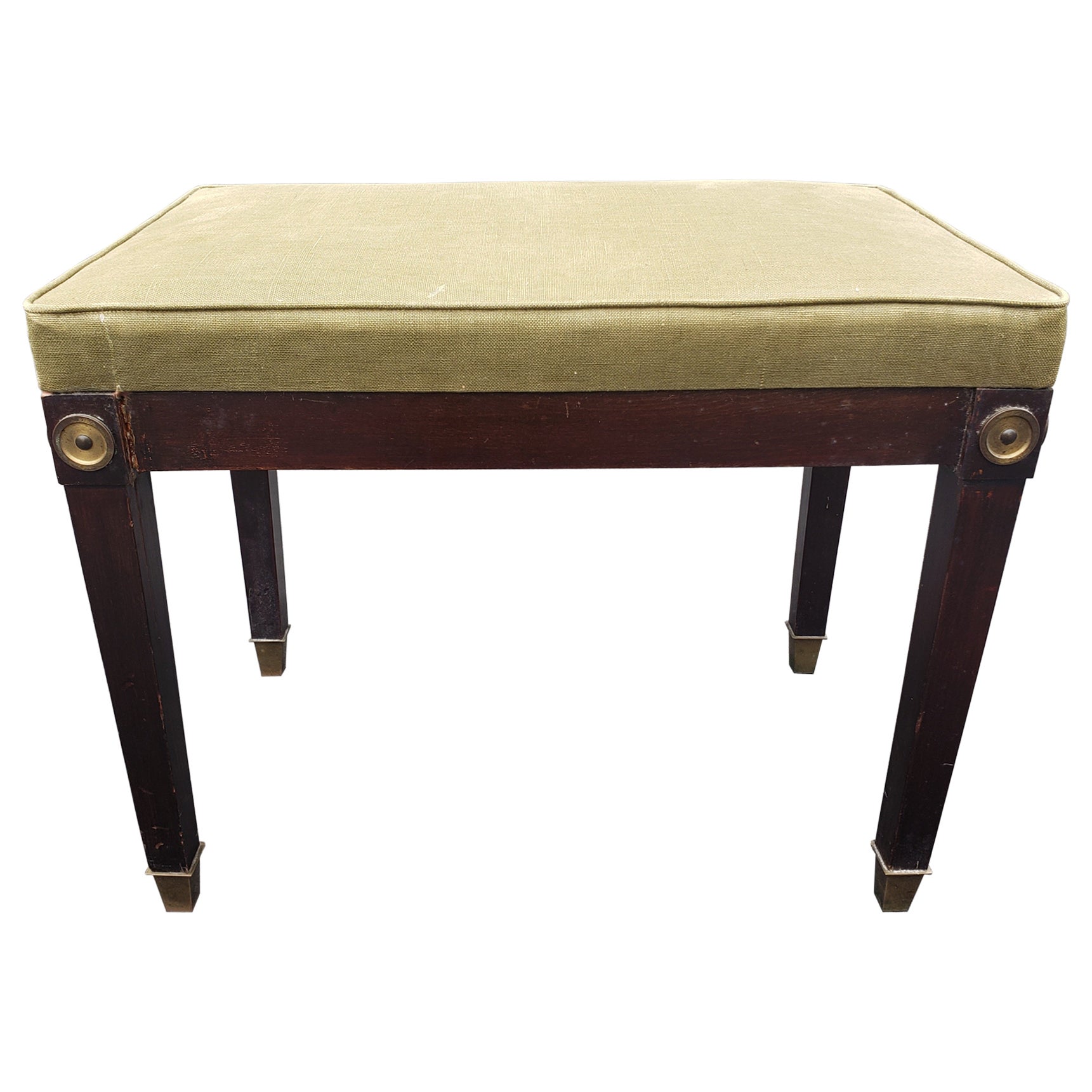An elegant 1940s Mahogany and Upholstered Bench with Brass Capped Legs and Medallions. Dark green upholstery with minor fading. Brass capped legs.